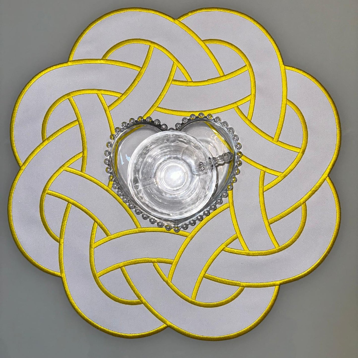 Round Placemat with Interlaced Design and Yellow Details